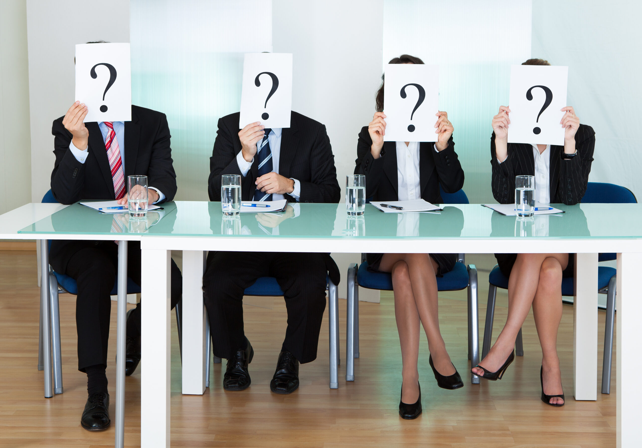 Row Of Businesspeople With Question Marks